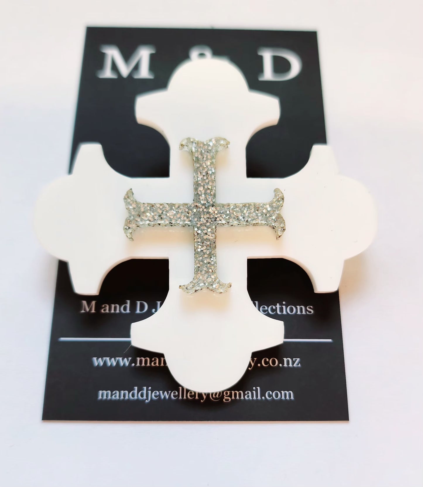 Brooch Black Botonee Cross with Silver Glitter bar layer.