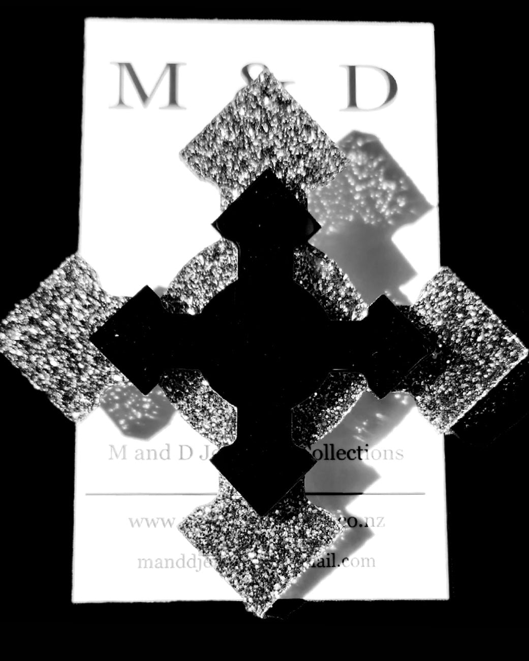 Brooch 4 point Black Glitter cross with layer.
