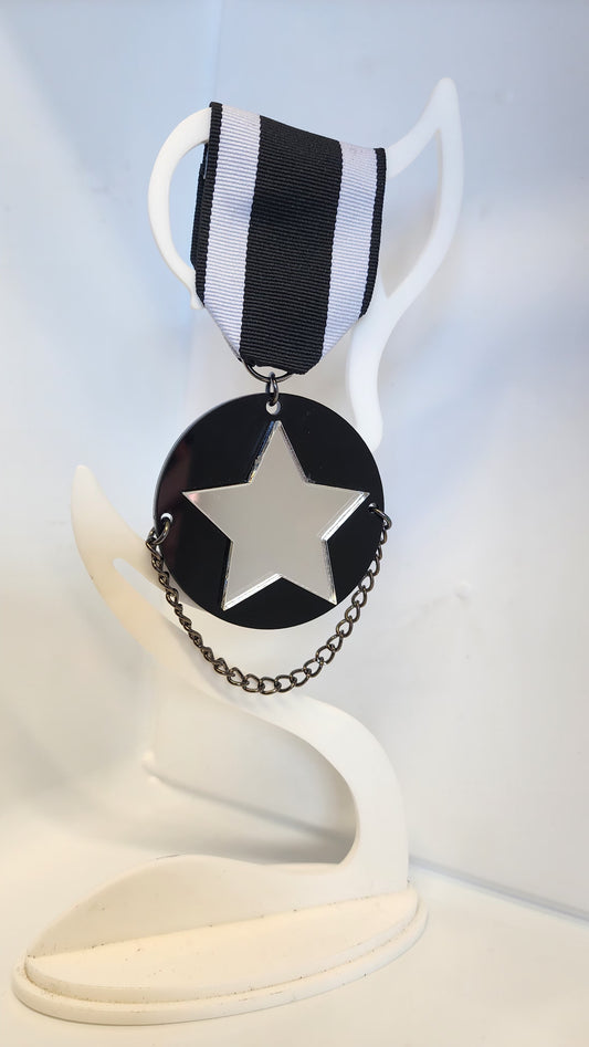 Ribbon Brooch Black Disc with Silver mirrored star and chain detail
